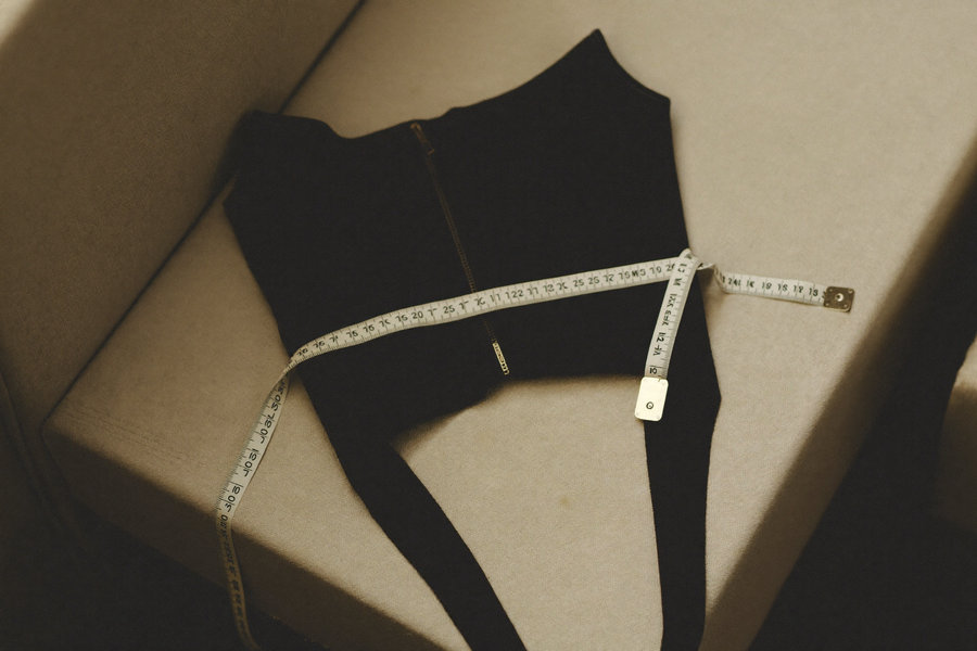 Soft tape measure draped over folded compression vest on bone surface