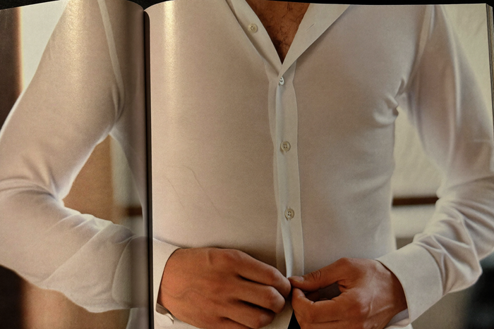 Three garments arranged on bone surface — vest, body, socks