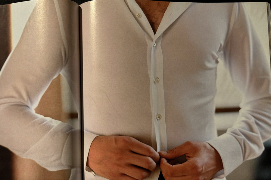 Three garments arranged on bone surface — vest, body, socks