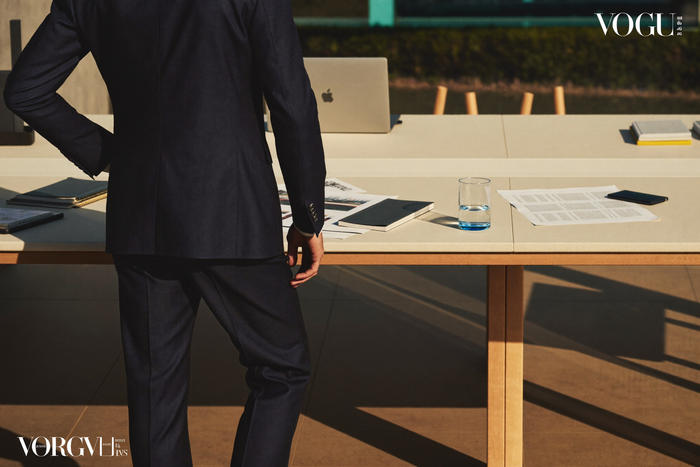 Distinguished older man in suit at study desk, posture upright