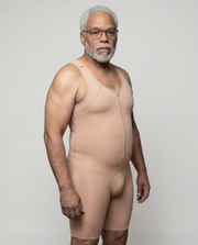 Man wearing a beige body shaper against a plain background
