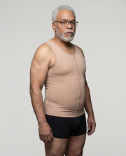 Man wearing a beige compression garment against a plain background