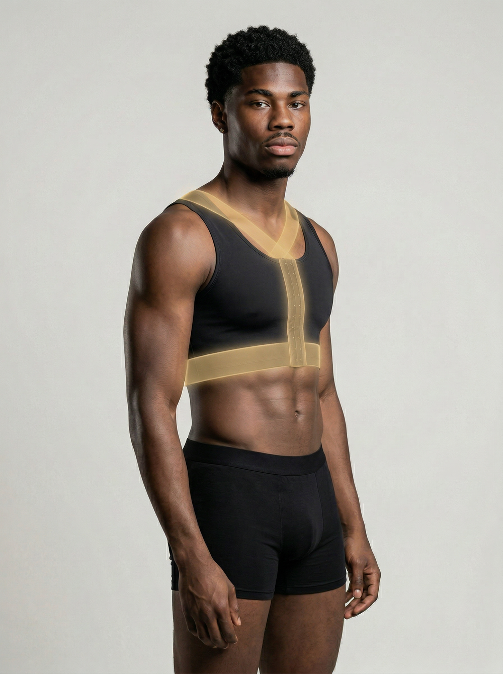 Man wearing a black and gold athletic outfit on a plain background
