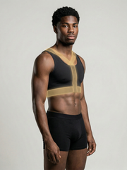 Man wearing a black and gold athletic outfit on a plain background
