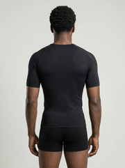 Person wearing a black athletic shirt and shorts on a light gray background