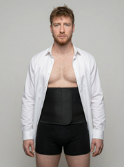 Man wearing a white shirt over black underwear with a gray background