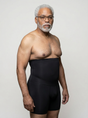 Man wearing the UNDR men's full-leg compression base layer in black, front view on a plain studio background