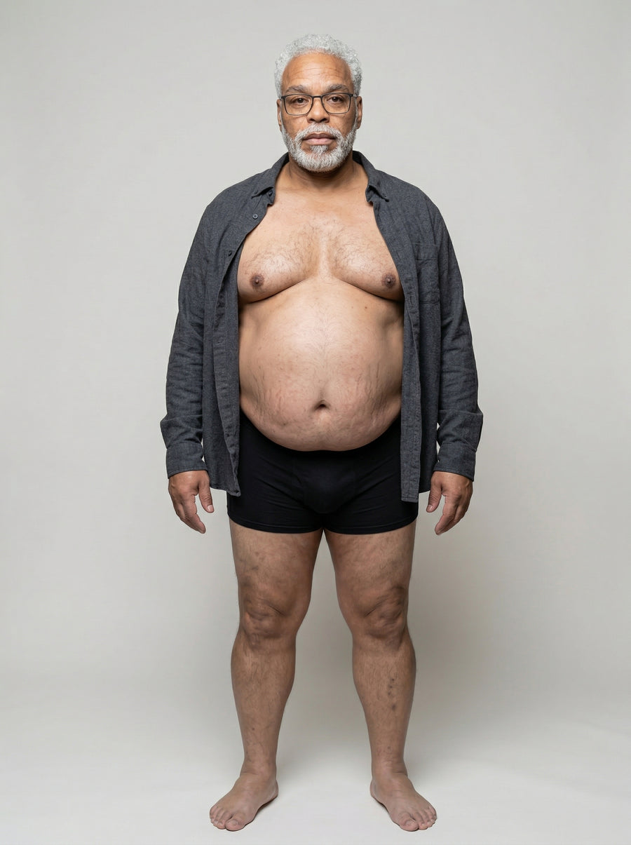 Man in a grey cardigan with the UNDR Zip Closure Compression Vest underneath