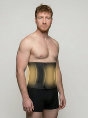 Man wearing a black compression garment with glowing yellow accents on a plain background