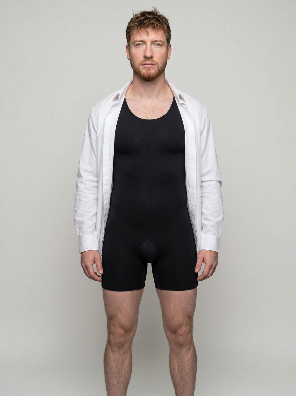 Man wearing a black unitard and white shirt against a plain background