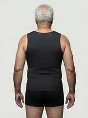 Man wearing a black tank top and shorts on a plain background